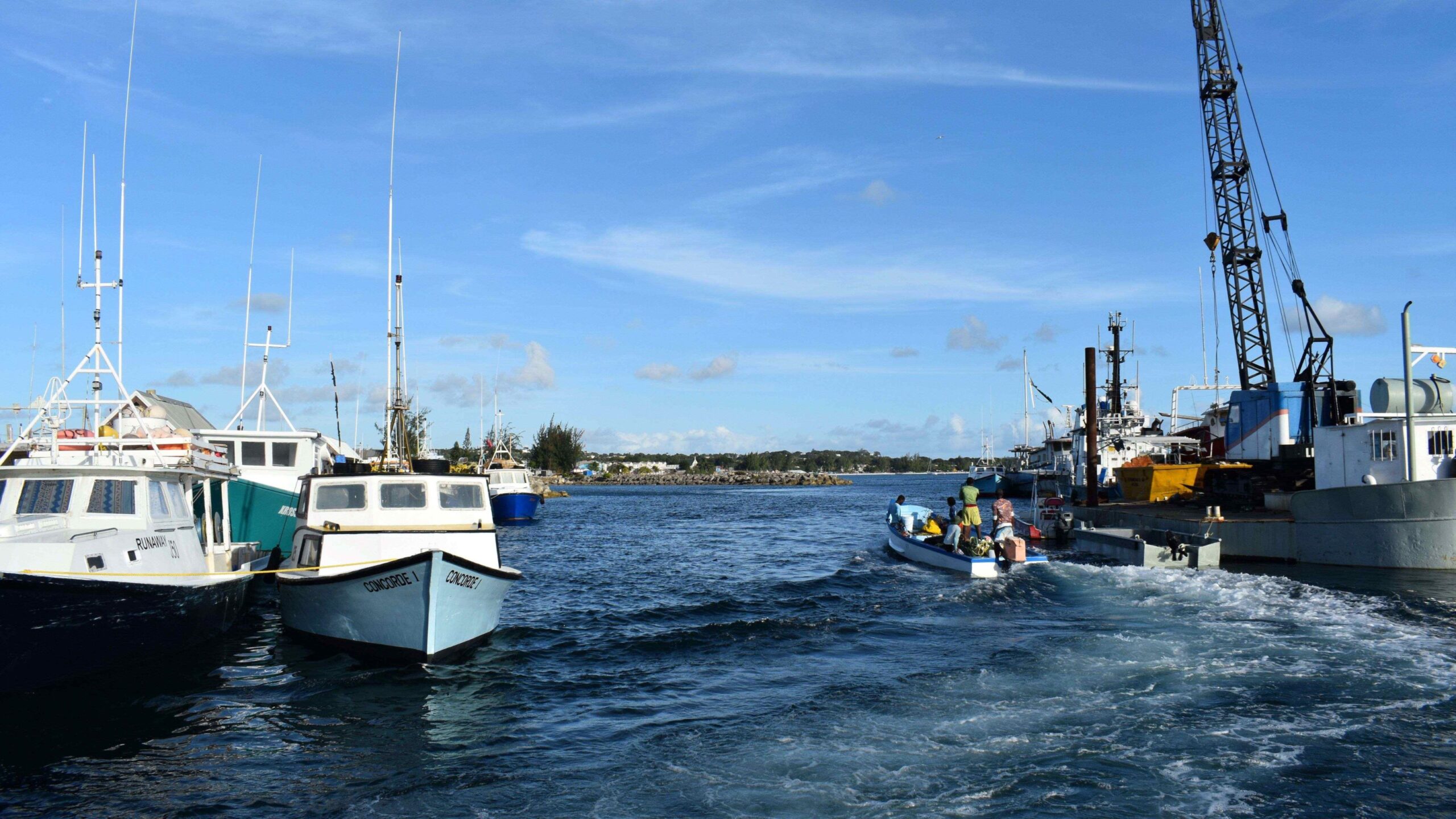 Photo of boats in the ocean near to the shore
